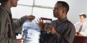 Men around water cooler in office in California